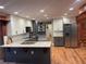 Spacious kitchen featuring granite countertops, stainless steel appliances, and gray lower cabinets at 1321 Earle Se Ct, Conyers, GA 30013