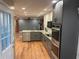 Modern kitchen features new gray and white cabinets, stainless appliances, and refinished floors at 1321 Earle Se Ct, Conyers, GA 30013