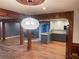 Open-concept kitchen featuring a decorative ceiling light fixture, wood columns and a cozy fireplace at 1321 Earle Se Ct, Conyers, GA 30013
