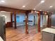 Open-concept living space with hardwood floors, wood columns and beams, with kitchen access at 1321 Earle Se Ct, Conyers, GA 30013