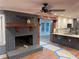 Cozy living room with a charming brick fireplace, open concept kitchen, and wood flooring at 1321 Earle Se Ct, Conyers, GA 30013