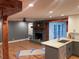 Inviting living room showcasing a brick fireplace, ceiling fan, and seamlessly open to the kitchen at 1321 Earle Se Ct, Conyers, GA 30013