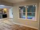 Bright living area featuring wood-look floors, white trim, and a glimpse of a renovated bathroom at 1321 Earle Se Ct, Conyers, GA 30013