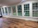 Sunroom with hardwood floors and plenty of large windows looking out to the backyard at 1321 Earle Se Ct, Conyers, GA 30013