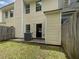 View of the home's exterior back with a small concrete patio and privacy fence at 25 Timber Ridge Dr, Cartersville, GA 30121