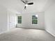 Spacious bedroom featuring a vaulted ceiling, carpet, and two windows for natural light at 25 Timber Ridge Dr, Cartersville, GA 30121