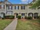 Charming townhome with a landscaped front yard, inviting walkway, and classic architectural details at 25 Timber Ridge Dr, Cartersville, GA 30121