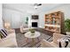 Bright living room with a fireplace, modern ceiling fan, and stylish decor at 25 Timber Ridge Dr, Cartersville, GA 30121