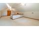 Spacious attic featuring carpeted flooring, wooden banisters, dormer lighting, and ample potential at 3394 Floral Ct, Suwanee, GA 30024