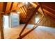 Unfinished attic features exposed rafters, wood flooring, insulation, and a window at 3394 Floral Ct, Suwanee, GA 30024