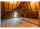 Unfinished attic featuring exposed rafters, wood flooring, insulation and a window at 3394 Floral Ct, Suwanee, GA 30024