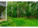 Exterior view of lush, green lawn and wooded backyard at 3394 Floral Ct, Suwanee, GA 30024