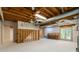 Unfinished basement with wooden beams, white walls, and door to backyard provides potential for customization at 3394 Floral Ct, Suwanee, GA 30024