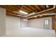 Unfinished basement area with white walls and door, offering potential for expansion and customization at 3394 Floral Ct, Suwanee, GA 30024