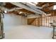 Open unfinished basement with wooden ceiling beams and painted floor offers a blank canvas for various uses at 3394 Floral Ct, Suwanee, GA 30024
