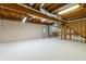 Spacious unfinished basement with white floors and walls offers great potential for future build-out at 3394 Floral Ct, Suwanee, GA 30024