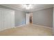 Spacious bedroom featuring neutral walls, plush carpeting, closet, and a ceiling fan at 3394 Floral Ct, Suwanee, GA 30024