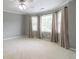 Bright bedroom with large windows and neutral decor creates a calming atmosphere at 3394 Floral Ct, Suwanee, GA 30024