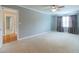 Bedroom featuring neutral walls, plush carpeting, and a ceiling fan at 3394 Floral Ct, Suwanee, GA 30024