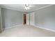 Spacious bedroom featuring neutral walls, plush carpeting, closet, and a ceiling fan at 3394 Floral Ct, Suwanee, GA 30024