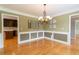 Dining area featuring a chandelier, with easy access to an adjacent kitchen at 3394 Floral Ct, Suwanee, GA 30024