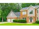 Charming two-story brick home with a three-car garage and manicured landscaping at 3394 Floral Ct, Suwanee, GA 30024