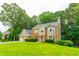 Beautiful two-story home featuring a three-car garage, brick facade, and large front yard at 3394 Floral Ct, Suwanee, GA 30024