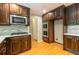 Bright kitchen featuring wood cabinets, stainless steel appliances, modern backsplash, and hardwood floors at 3394 Floral Ct, Suwanee, GA 30024