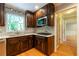 Updated kitchen with wood cabinets, white countertops, tile backsplash, stainless steel appliances, and natural light at 3394 Floral Ct, Suwanee, GA 30024