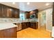 Well-lit kitchen featuring wood cabinets, tile backsplash, stainless steel appliances, and gleaming hardwood floors at 3394 Floral Ct, Suwanee, GA 30024