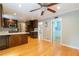 Bright kitchen featuring wood cabinets, stainless steel appliances, hardwood floors, and adjacent living space at 3394 Floral Ct, Suwanee, GA 30024
