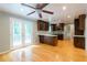 Bright kitchen with dark cabinetry, hardwood floors, and french doors leading to the back deck at 3394 Floral Ct, Suwanee, GA 30024