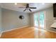 Living room featuring natural light, gray walls, hardwood floors, and access to an outdoor balcony at 3394 Floral Ct, Suwanee, GA 30024
