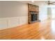 Living room features a stone fireplace with a wooden mantle and light hardwood flooring at 3394 Floral Ct, Suwanee, GA 30024