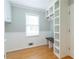 Mudroom with custom shelving, built-in bench, and hardwood floors, a great space for organizing at 3394 Floral Ct, Suwanee, GA 30024