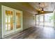Screened porch with wood-look floors and modern lighting, offering a cozy transition between indoors and outdoors at 3394 Floral Ct, Suwanee, GA 30024