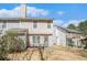 View of the home's backyard with patio seating, partial fencing, and ample space for outdoor activities at 4211 Wingfoot Ct, Decatur, GA 30035