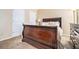 Bedroom featuring a wooden sleigh bed with plush carpet and neutral walls at 4211 Wingfoot Ct, Decatur, GA 30035