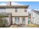 Exterior rear view of the townhome with patio, small seating area and well-maintained backyard at 4211 Wingfoot Ct, Decatur, GA 30035