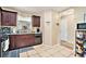 Functional kitchen with granite countertops, dark cabinets, and tiled flooring at 4211 Wingfoot Ct, Decatur, GA 30035