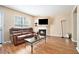 Comfortable living room with a fireplace, hardwood floors, and a plush leather sofa at 4211 Wingfoot Ct, Decatur, GA 30035