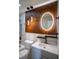 Modern bathroom featuring a vanity with a stylish lighted mirror and decorative wall paneling at 5072 Plantation View Trl, Stone Mountain, GA 30088