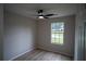 This bedroom features a ceiling fan, wood-look flooring, and window at 5072 Plantation View Trl, Stone Mountain, GA 30088