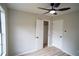 Cozy bedroom features modern ceiling fan, fresh paint, and wood-look flooring at 5072 Plantation View Trl, Stone Mountain, GA 30088