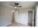 This is a bedroom with an open closet, white doors, gray paint, and ceiling fan at 5072 Plantation View Trl, Stone Mountain, GA 30088
