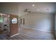 Open-concept living room with a high ceiling, modern ceiling fan, and a decorative accent wall at 5072 Plantation View Trl, Stone Mountain, GA 30088