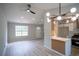 Bright living space with modern lighting fixtures, a breakfast bar, and seamless access to kitchen at 5072 Plantation View Trl, Stone Mountain, GA 30088