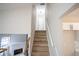 Bright stairway with wooden steps and white walls, leading to the upper level at 5072 Plantation View Trl, Stone Mountain, GA 30088