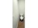 Compact half bathroom featuring a standard toilet, door, and minimalist design at 5518 Legacy Trl, Douglasville, GA 30135