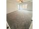 Bright primary bedroom features neutral carpeting, ceiling fan, and abundant natural light at 5518 Legacy Trl, Douglasville, GA 30135